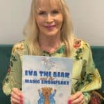 Dr Pam Spurr holding Eva The Bear book